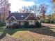 Attractive single-story brick home with a well-maintained lawn and mature trees at 909 Woodhurst Dr, Monroe, NC 28110