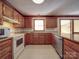 Traditional kitchen with wooden cabinets, tile floors, and granite countertops at 909 Woodhurst Dr, Monroe, NC 28110
