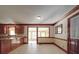 An open-concept kitchen and breakfast nook with tile flooring and wooden trim at 909 Woodhurst Dr, Monroe, NC 28110