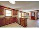 A kitchen with granite countertops, oak cabinets, and lots of natural light at 909 Woodhurst Dr, Monroe, NC 28110