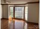 Cozy living room with hardwood floors and a large bay window at 909 Woodhurst Dr, Monroe, NC 28110