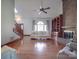 Living room has a brick fireplace with bookcases, wood floors, and large windows for natural light at 909 Woodhurst Dr, Monroe, NC 28110