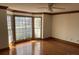 Bright living room featuring hardwood floors, large bay windows, and a ceiling fan at 909 Woodhurst Dr, Monroe, NC 28110