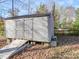 Wooden shed with ramp access, perfect for storage and outdoor projects at 909 Woodhurst Dr, Monroe, NC 28110