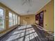 Bright sun room with large windows, ceiling fans, and wood-look flooring at 909 Woodhurst Dr, Monroe, NC 28110