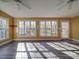 Sun-filled living room with large windows, ceiling fans, and modern flooring at 909 Woodhurst Dr, Monroe, NC 28110