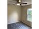 A cozy bedroom features neutral paint, a ceiling fan with light, and a window for natural light at 1067 19Th Ne St # B, Hickory, NC 28601