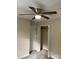A neutral bedroom includes a ceiling fan, a closet with bifold doors, and a secondary door at 1067 19Th Ne St # B, Hickory, NC 28601