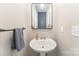 Small bathroom with pedestal sink and vanity mirror at 126 Walleye Ln, Troutman, NC 28166