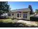 Backyard with a patio, bay window, and back door, and lush greenery under a clear blue sky at 14301 Beryl Ct, Pineville, NC 28134