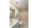 This bathroom features a tub shower, toilet, vanity, mirror, and a window for natural light at 14301 Beryl Ct, Pineville, NC 28134