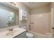 Bright bathroom with a tub, shower combination and vanity with a mirror and window at 14301 Beryl Ct, Pineville, NC 28134