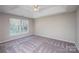 Serene bedroom featuring plush carpet, ceiling fan, and lots of light from the double windows at 14301 Beryl Ct, Pineville, NC 28134