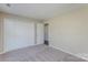 Bedroom featuring carpet flooring, a closet and a door at 14301 Beryl Ct, Pineville, NC 28134