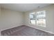 This bright bedroom has carpet floors and a window that lets in natural light at 14301 Beryl Ct, Pineville, NC 28134