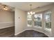 Dining nook includes modern lighting, wood floors, and abundant light from windows at 14301 Beryl Ct, Pineville, NC 28134