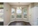 Cozy dining area features bright bay window, chandelier and wood-look floors at 14301 Beryl Ct, Pineville, NC 28134