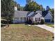Beautiful home with a well-manicured lawn, colorful landscaping, and red shuttered windows at 14301 Beryl Ct, Pineville, NC 28134