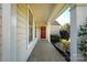 Covered front porch offers a red front door, view of the yard, and a nice entryway at 14301 Beryl Ct, Pineville, NC 28134
