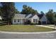 Single-story home with a manicured lawn, colorful landscaping, and a view of the cul-de-sac at 14301 Beryl Ct, Pineville, NC 28134