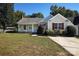 Charming single-story home with a well-maintained lawn, red shutters, and mature landscaping at 14301 Beryl Ct, Pineville, NC 28134