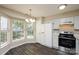 Bright eat-in kitchen features ample counter space, white appliances and modern lighting at 14301 Beryl Ct, Pineville, NC 28134