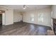 Spacious living room with modern flooring, fireplace, and natural light from the large windows at 14301 Beryl Ct, Pineville, NC 28134