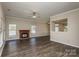Bright living room features a fireplace, hardwood floors, and a ceiling fan at 14301 Beryl Ct, Pineville, NC 28134