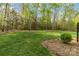 Expansive backyard with lush green lawn and mature trees, creating a serene outdoor space at 9723 Sedgefield Dr, Waxhaw, NC 28173