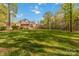 Large backyard with well-maintained lawn and mature trees, offering privacy and plenty of space at 9723 Sedgefield Dr, Waxhaw, NC 28173