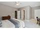 Bedroom featuring neutral walls, windows, ceiling fan, and bathroom and closet access at 9723 Sedgefield Dr, Waxhaw, NC 28173
