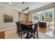 Open concept dining room adjacent to kitchen featuring hardwood floors and elegant lighting at 9723 Sedgefield Dr, Waxhaw, NC 28173