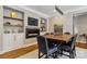 Stylish dining room features a modern fireplace, TV, and a large wooden table with seating for six at 9723 Sedgefield Dr, Waxhaw, NC 28173