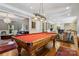 Bright game room featuring a pool table, elegant lighting, and stylish seating, perfect for entertaining at 9723 Sedgefield Dr, Waxhaw, NC 28173