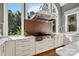 Beautiful kitchen with white cabinets, stainless steel range hood, and marble counters at 9723 Sedgefield Dr, Waxhaw, NC 28173