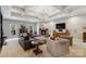 Spacious living room with coffered ceilings, a stone fireplace, and large windows allowing for natural light at 9723 Sedgefield Dr, Waxhaw, NC 28173