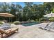 Relaxing backyard pool with stone waterfall feature and lounge chairs, perfect for outdoor entertaining at 9723 Sedgefield Dr, Waxhaw, NC 28173
