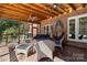 Screened porch with brick ceiling, ceiling fans, and outdoor seating area at 9723 Sedgefield Dr, Waxhaw, NC 28173