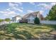 Spacious backyard with green grass, a deck, and a white fence offers a serene outdoor space for recreation and relaxation at 1001 Hatton Ter, Fort Mill, SC 29707