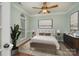 Cozy bedroom with a neutral color palette, a decorative ceiling fan, and natural light from the arched window at 1001 Hatton Ter, Fort Mill, SC 29707