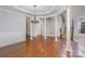 Elegant dining room with hardwood floors, columns, and a stylish chandelier at 1001 Hatton Ter, Fort Mill, SC 29707