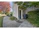 Exterior entrance to home featuring a well-maintained walkway, a tidy yard, and convenient trash receptacles at 1001 Hatton Ter, Fort Mill, SC 29707