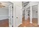 Welcoming foyer with hardwood floors, columns, an open staircase, and a view into other living spaces at 1001 Hatton Ter, Fort Mill, SC 29707