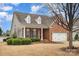 Charming brick home featuring a two-car garage and well-manicured landscaping at 1001 Hatton Ter, Fort Mill, SC 29707