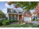 Charming brick home with manicured lawn and garden beds, featuring a welcoming front porch and attached garage at 1001 Hatton Ter, Fort Mill, SC 29707