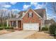 Charming brick home featuring a two-car garage and well-manicured landscaping at 1001 Hatton Ter, Fort Mill, SC 29707