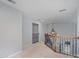 Hallway with carpet, wood railing, and black wrought iron spindles at 1001 Hatton Ter, Fort Mill, SC 29707