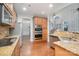 Updated kitchen with granite countertops, stainless steel appliances, and a view into the adjacent living spaces at 1001 Hatton Ter, Fort Mill, SC 29707