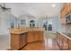 Kitchen with wooden cabinetry, granite countertops, stainless steel appliances, and an eat-in bar at 1001 Hatton Ter, Fort Mill, SC 29707