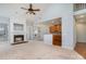 Open-concept living area featuring a fireplace, a cathedral ceiling, and a view into the adjacent kitchen at 1001 Hatton Ter, Fort Mill, SC 29707